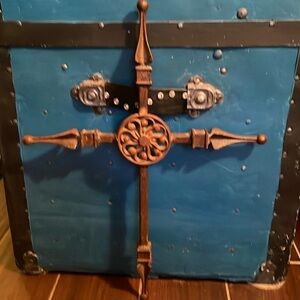 Cast Iron Scrollwork Cross Wall Art it has a floral design in the middle